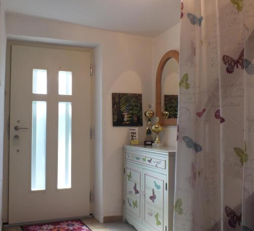 a room with a door and a dresser and a window at Ferienhaus Landau in Landau an der Isar