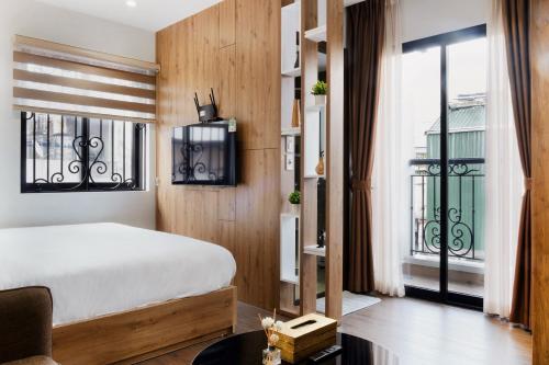 a bedroom with a bed and a large window at Studio apartment in Hoan Kiem in Hanoi