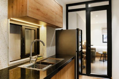 a kitchen with a sink and a refrigerator at Studio apartment in Hoan Kiem in Hanoi