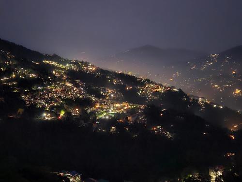 a view of a city lit up at night at The Bliss Homestay in Gangtok