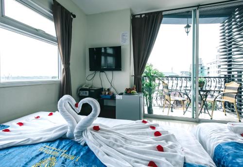 a bedroom with two swans made to look like hearts at V Hotel Vientiane in Vientiane