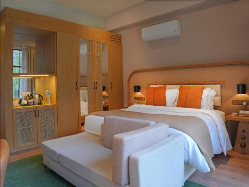 a bedroom with a large bed and a couch at Ambiance Resort Hunza in Hunza
