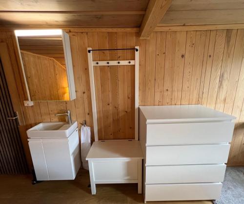 a small bathroom with a sink and a toilet at Haus Bergmann in Boltigen