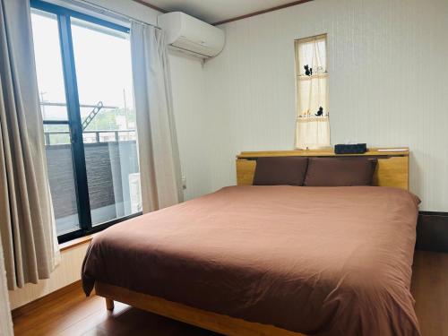 Postel nebo postele na pokoji v ubytování The Ritz Okinawa Kise1-Free parking for 2 cars, 3LDK, 2 bathrooms