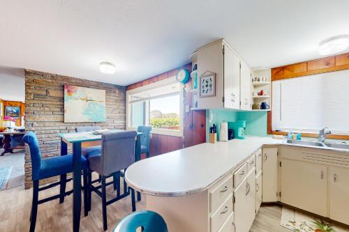 a kitchen with a table and chairs and a dining room at Coastal Vista Retreat in Coos Bay