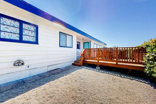a house with a deck on the side of it at Coastal Vista Retreat in Coos Bay