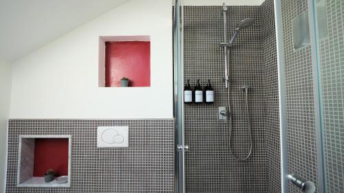 a bathroom with a shower with a glass door at Blu Note Apartment in Turin