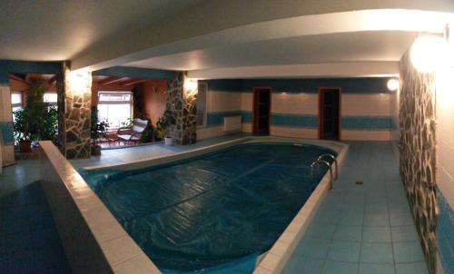 a large swimming pool in a hotel room at Penzion Zelený Dom in Vitanová