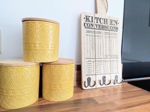 three yellow containers sitting on top of a wooden floor at 'Serenity in Somerset ' Self Catering House Rental Near Chard , Accomodation for Contract Workers only in Chardstock