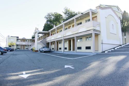 an empty parking lot in front of a building at Domino Inn in North Bergen