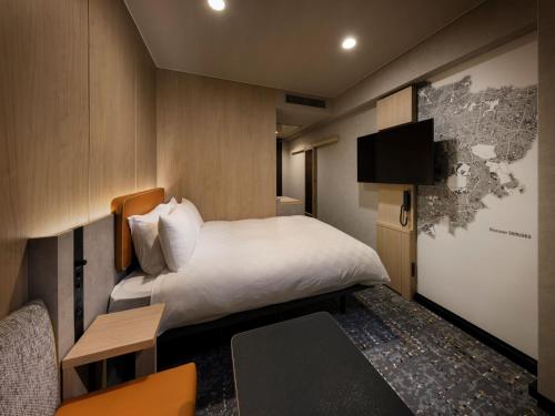 a hotel room with a bed and a tv at Shinjuku Prince Hotel in Tokyo