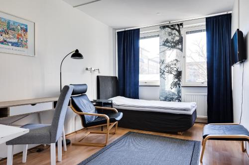 a room with a bed and a desk and a chair at Drottninggatans Vandrarhem in Karlskrona