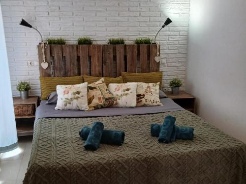 a bedroom with a bed with two pairs of shoes on it at Nuestra Casa en Gran Alacant in Gran Alacant