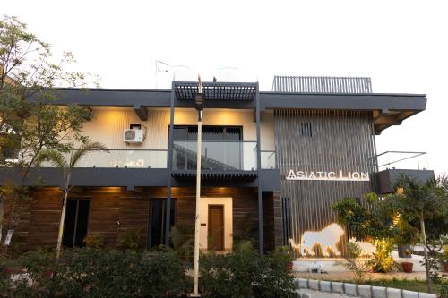 a house with a sign that reads australian inn at Daksh Eden Greenz -A Luxury Resort in Sasan Gir in Sasan Gir
