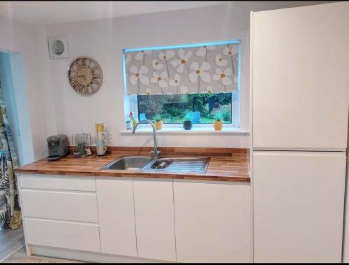 a kitchen with a sink and a window at 'Serenity in Somerset ' Self Catering House Rental Near Chard , Accomodation for Contract Workers only in Chardstock