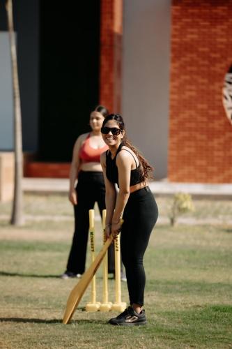 a woman in a bikini holding a baseball bat at Daksh Eden Greenz -A Luxury Resort in Sasan Gir in Sasan Gir