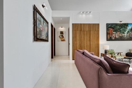 a living room with two couches and a table at New 3 BR Jungle Villa in gated community in Blahbatu