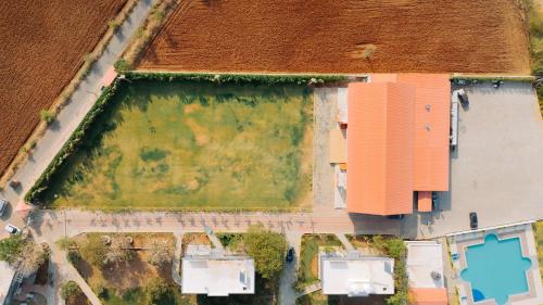 an overhead view of a large building with a green field at Daksh Eden Greenz -A Luxury Resort in Sasan Gir in Sasan Gir