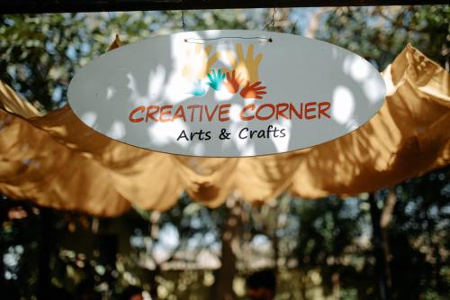 a sign that reads creative corner arts and crafts at Daksh Eden Greenz -A Luxury Resort in Sasan Gir in Sasan Gir