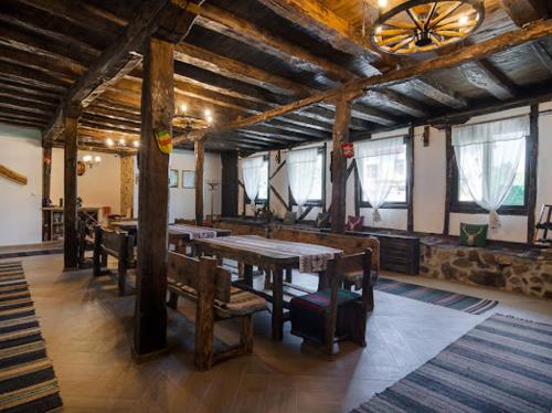 a large room with tables and benches in a building at Къща "Конакъ" in Kyustendil