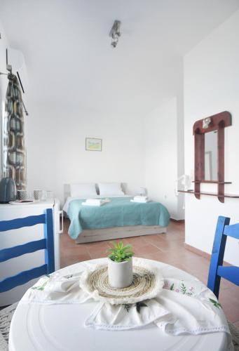 a living room with a table and two beds at Agialos Rooms in Kalymnos