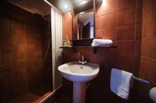 a bathroom with a sink and a shower with a mirror at Agialos Rooms in Kalymnos