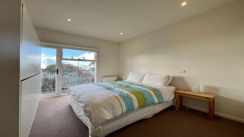a bedroom with a large bed and a window at K2 - Thirteen in Mount Buller