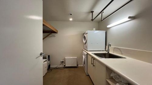 a small kitchen with a sink and a refrigerator at K2 - Thirteen in Mount Buller
