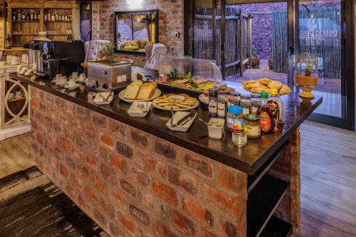 a buffet of food on a brick counter in a kitchen at Desert Hills Glamping Camp in Sesriem