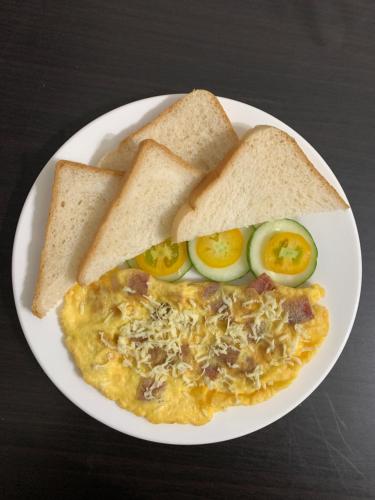 a plate of food with eggs and bread and toast at LS Garden Villa in Puerto Princesa City