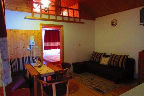 a living room with a couch and a table at Chata u vinára Milana, Tatralandia in Liptovský Mikuláš