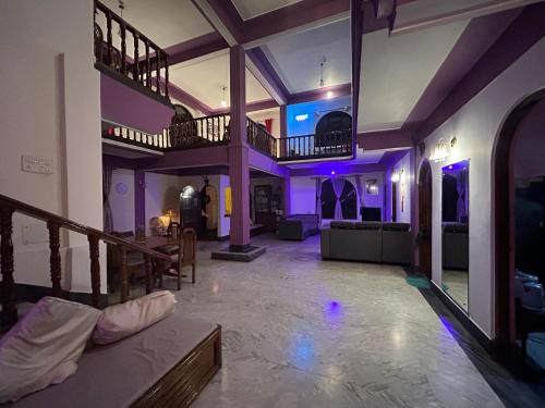 a large living room with purple lighting in a house at Tashila Hostel in Gangtok