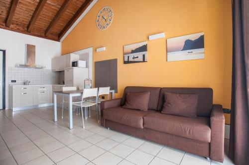 a living room with a couch and a table at Residence Maroadi in Nago-Torbole
