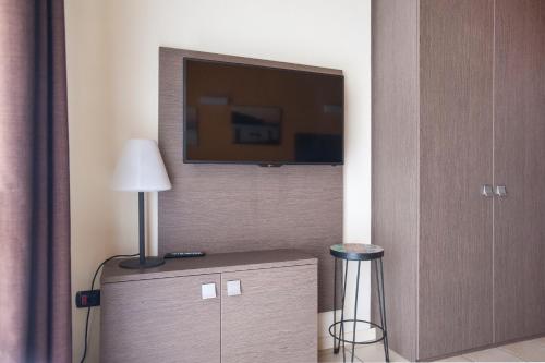 a room with a flat screen tv on a wall at Residence Maroadi in Nago-Torbole