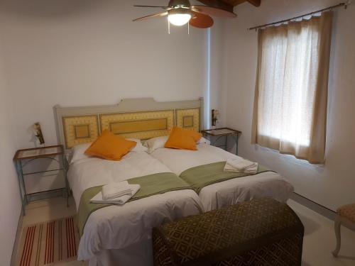 a bedroom with two beds with orange pillows on them at Casas de La Ermita VTAR TANA in Puerto-Gil