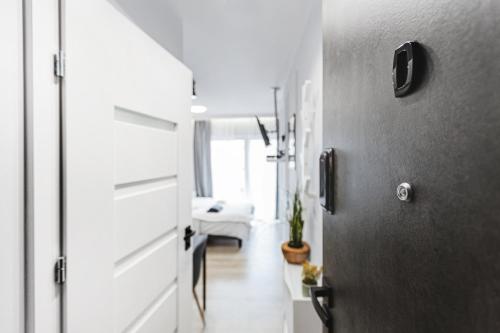 a hallway with a door and a living room at Stylowe Apartamenty w Centrum in Wrocław
