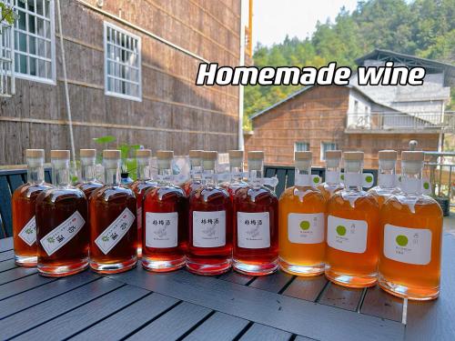 a bunch of bottles of honey sitting on a table at Tongfu Inn(In the National Park) in Zhangjiajie