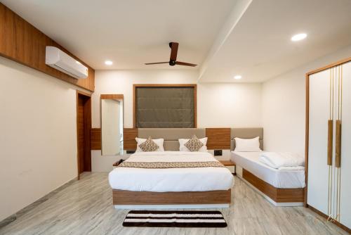 a bedroom with two beds and a chalkboard on the wall at Daksh Eden Greenz -A Luxury Resort in Sasan Gir in Sasan Gir