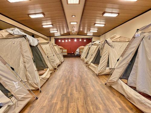 a row of tents in a room with a wooden floor at 日本旅館　松亀荘 in Beppu