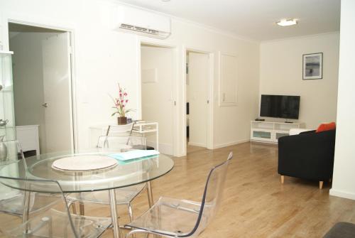 a living room with a glass table and a couch at Mill View Link in Albany