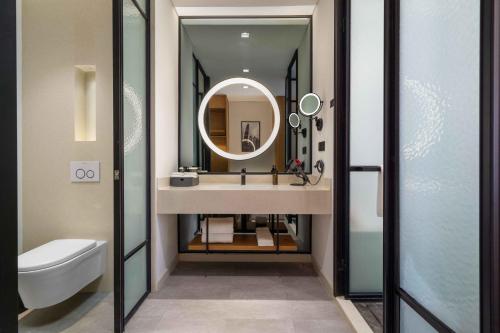 a bathroom with a sink and a mirror at UrCove by Hyatt Guangzhou Tower Pazhou Exhibition Center in Guangzhou