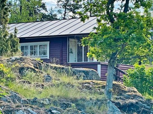 a purple house with a tree in front of it at 5 person holiday home in NYNÄSHAMN-By Traum in Nynäshamn