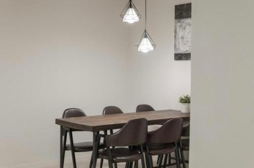 a dining room with a wooden table and chairs at La Famille in Yangyang