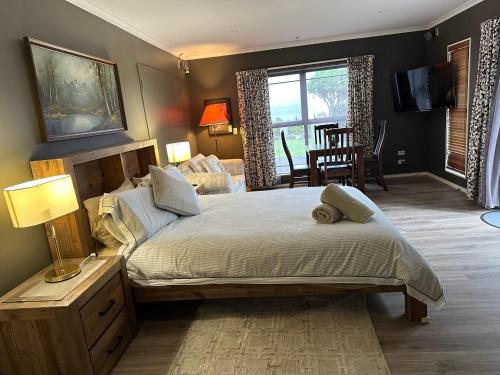 a bedroom with a large bed and a living room at Lakeview Holiday Hideaway in Taupo