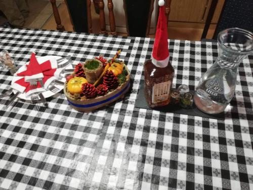 a table with a bowl of fruit and a bottle of sauce at Apartmani Feliks in Resavica
