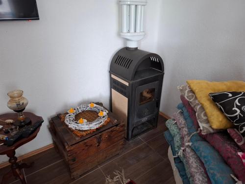 a living room with a wood stove and a couch at Apartmani Feliks in Resavica
