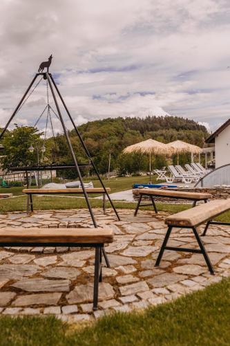 a park with two picnic tables and a swing at Dzikowiejsko in Bardo