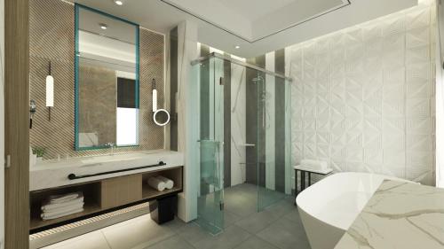 y baño con ducha acristalada y lavamanos. en Hyatt Place Makassar, en Makassar