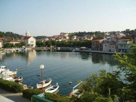 a river with boats docked in a town at Apartment Ivante in Zaton