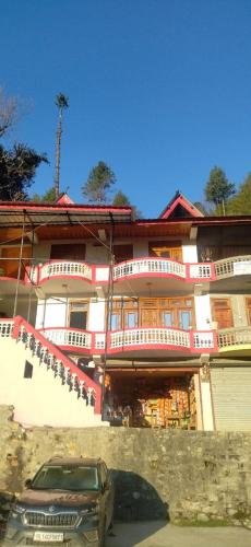 a car parked in front of a building at Fresh View Homestay in Sainj